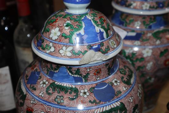 A pair of Chinese porcelain wucai jars and covers, late 19th/early 20th century height 36cm (a.f.)